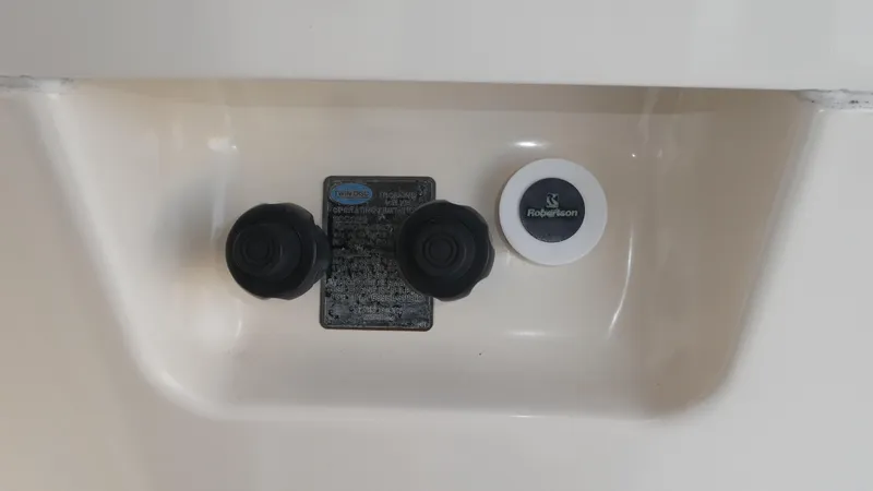 Slide: The Image of Control panel of a 1995 Riviera Convertible boat with knobs and Robertson label. - 47