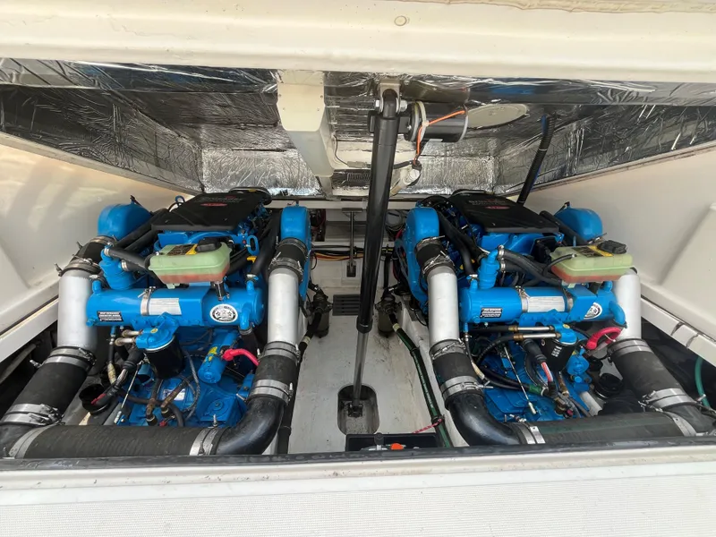 Slide: The Image of Engine compartment of a 2005 Tiara Yachts 2900 Coronet, featuring dual blue engines. - 12