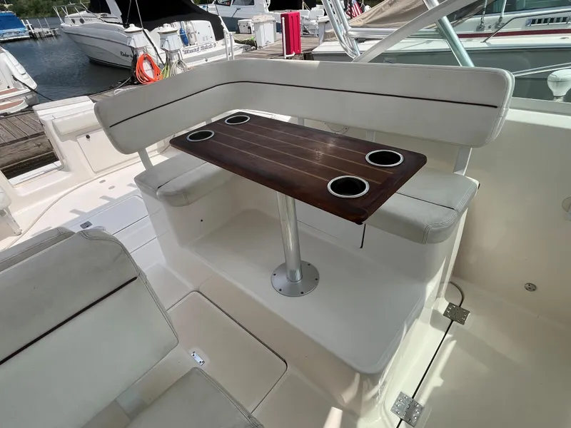 Slide: The Image of 2005 Tiara Yachts 2900 Coronet interior with cushioned seating and wooden table. - 13