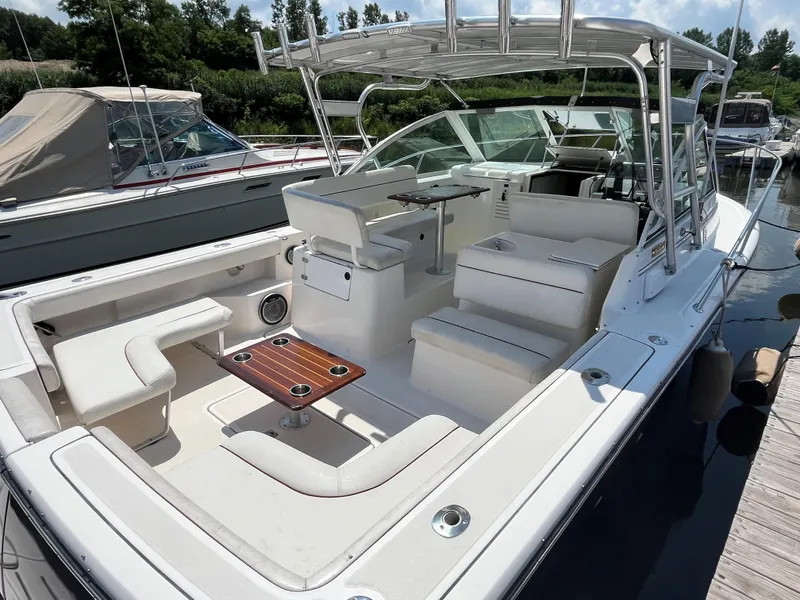 Slide: The Image of 2005 Tiara Yachts 2900 Coronet with spacious seating and sleek design docked at marina. - 19