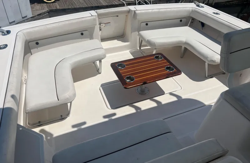 Slide: The Image of 2005 Tiara Yachts 2900 Coronet interior with white seating and wooden table. - 20