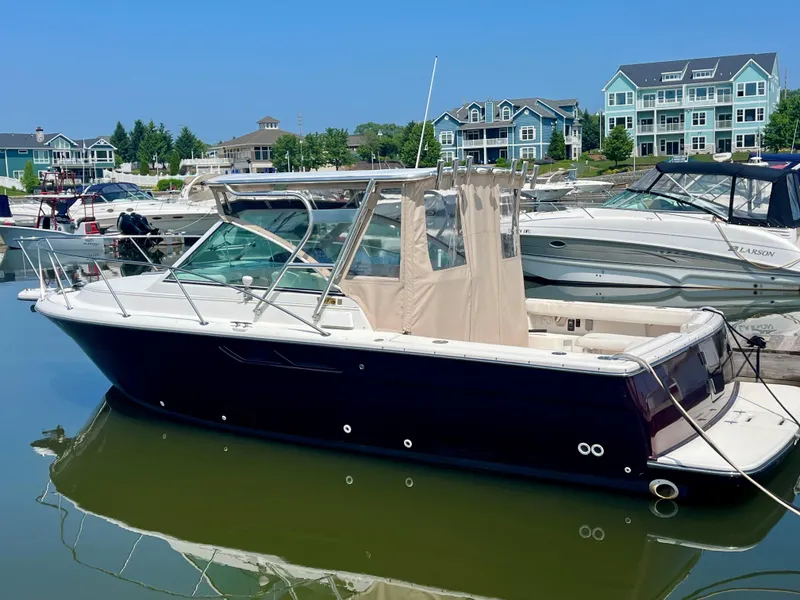 Slide: The Image of 2005 Tiara Yachts 2900 Coronet docked in a marina with waterfront homes. - 3