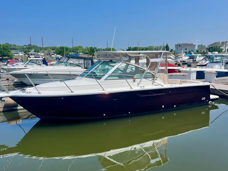 Slide: The Image of 2005 Tiara Yachts 2900 Coronet docked in a marina under clear blue skies. - 4