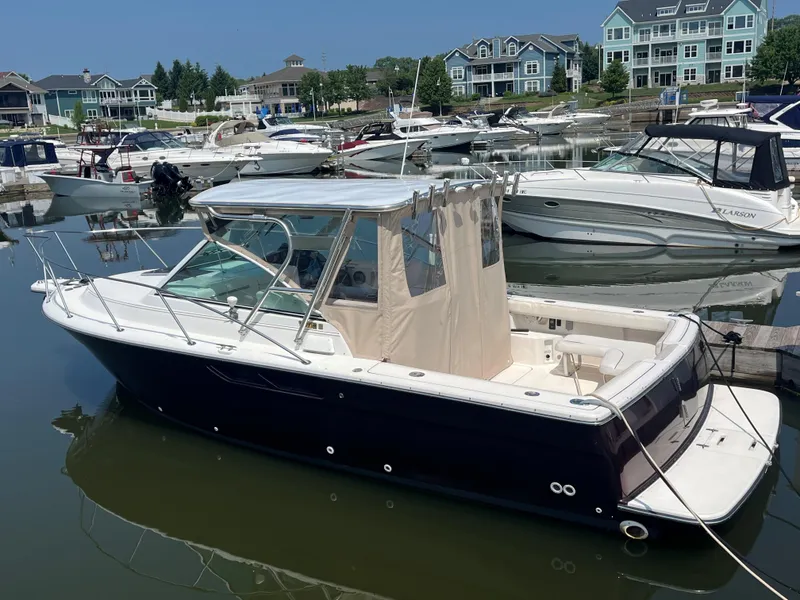 Slide: The Image of 2005 Tiara Yachts 2900 Coronet docked in a marina with other boats. - 5