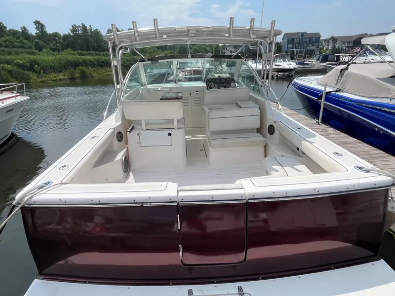 Slide: The Image of 2005 Tiara Yachts 2900 Coronet docked, showcasing spacious cockpit and seating area. - 7