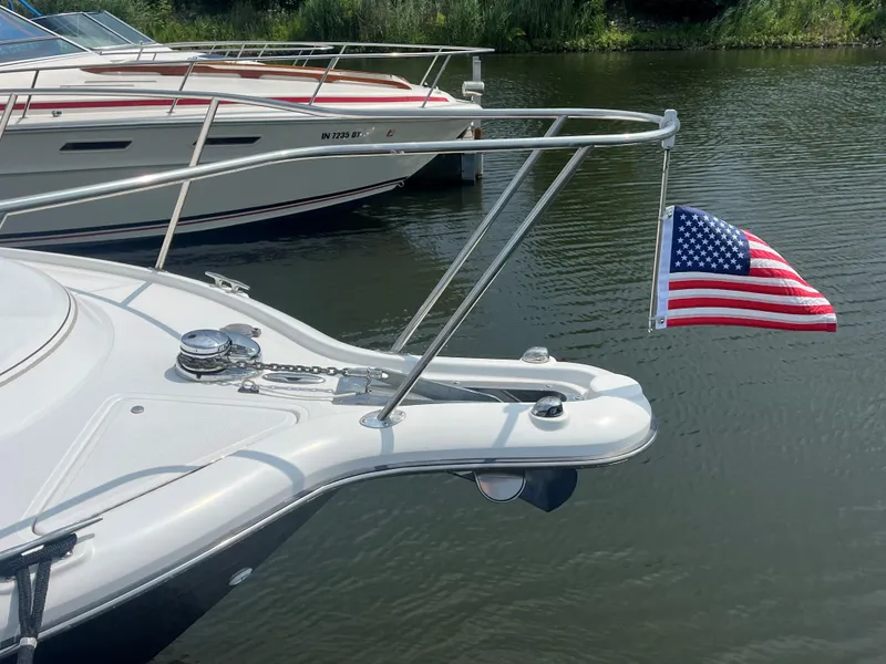Slide: The Image of 2005 Tiara Yachts 2900 Coronet with American flag, docked on calm water. - 8