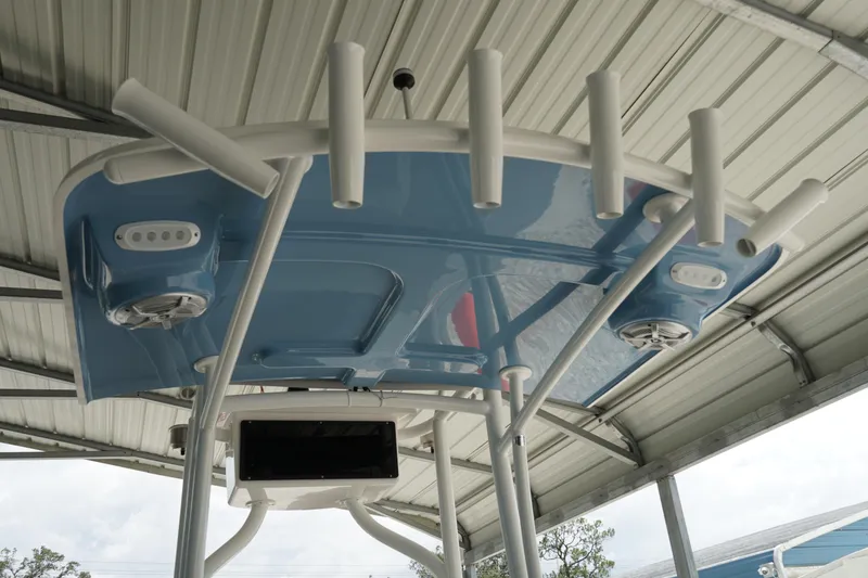Slide: The Image of 2026 May-Craft 238 Center Console boat's T-top with rod holders and speakers. - 11