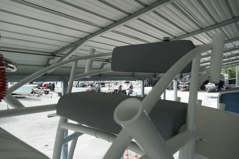 Slide: The Image of 2026 May-Craft 238 Center Console boat under metal shelter, showcasing seating and structure. - 12