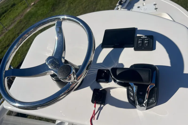 Slide: The Image of Steering console of 2026 May-Craft 238 Center Console boat with controls and display. - 14