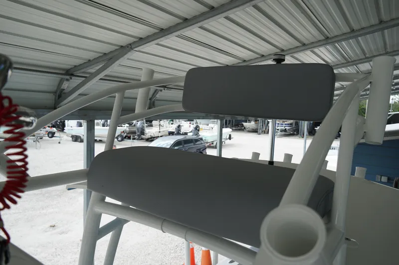Slide: The Image of 2026 May-Craft 238 Center Console boat under a metal canopy, showcasing seating area. - 15
