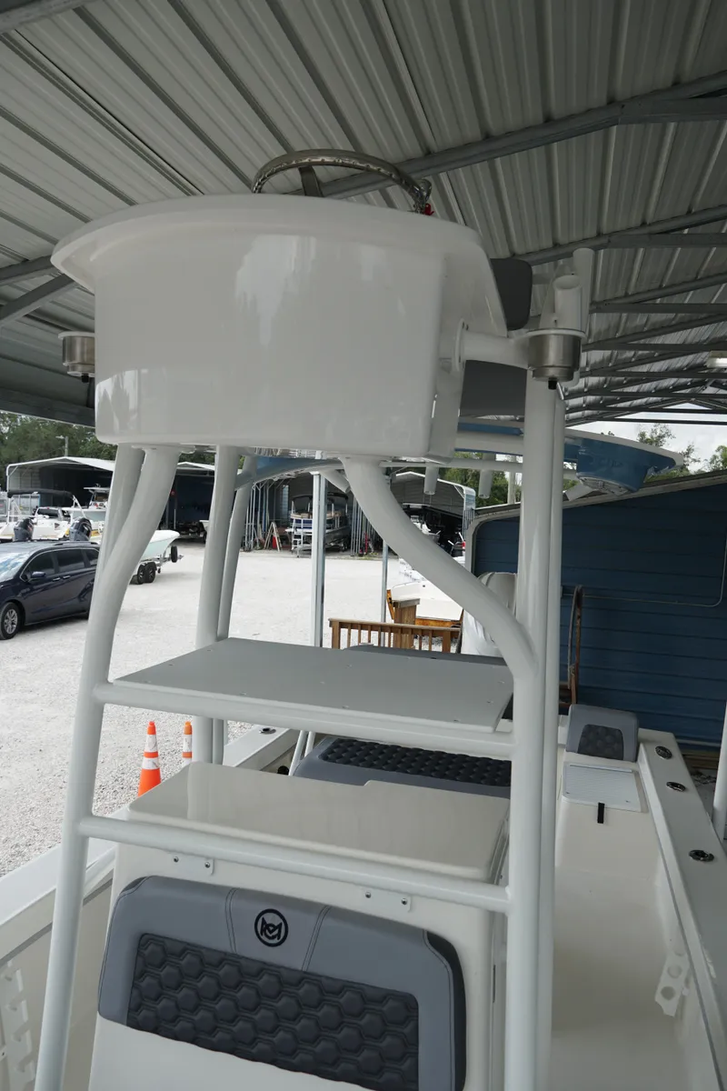 Slide: The Image of 2026 May-Craft 238 Center Console boat under metal canopy, showcasing upper deck and seating. - 17