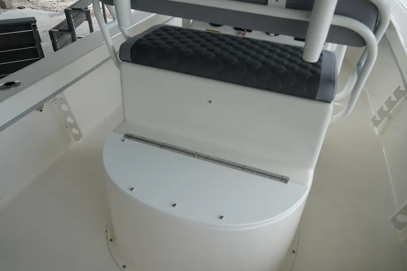 Slide: The Image of 2026 May-Craft 238 Center Console boat interior with cushioned seating and storage compartment. - 23