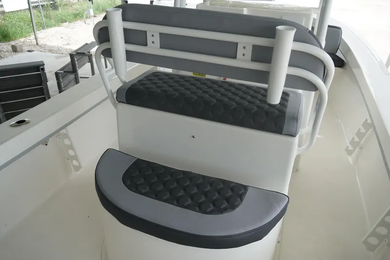 Slide: The Image of 2026 May-Craft 238 Center Console boat seating with cushioned backrest and rod holders. - 27
