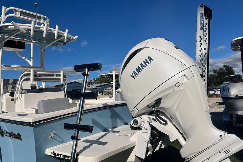 Slide: The Image of 2026 May-Craft 238 Center Console boat with Yamaha outboard motor, docked under clear blue sky. - 3
