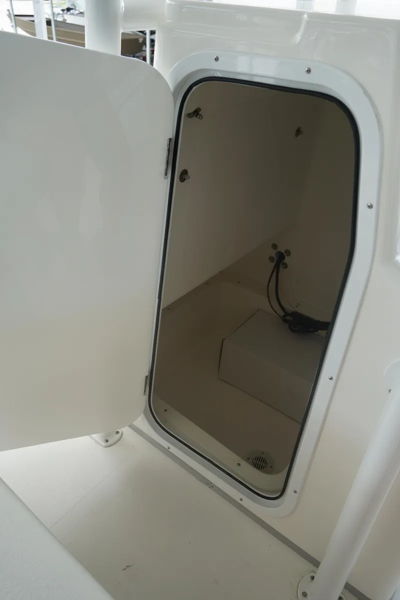 Slide: The Image of Open storage compartment on 2026 May-Craft 238 Center Console boat. - 39