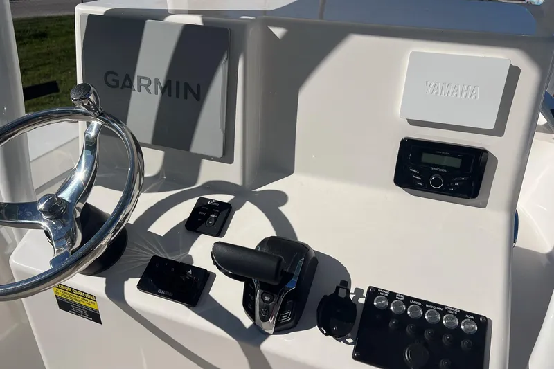 Slide: The Image of 2026 May-Craft 238 Center Console dashboard with Garmin and Yamaha controls. - 42