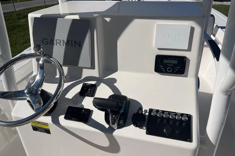 Slide: The Image of 2026 May-Craft 238 Center Console dashboard with Garmin and Yamaha controls. - 43