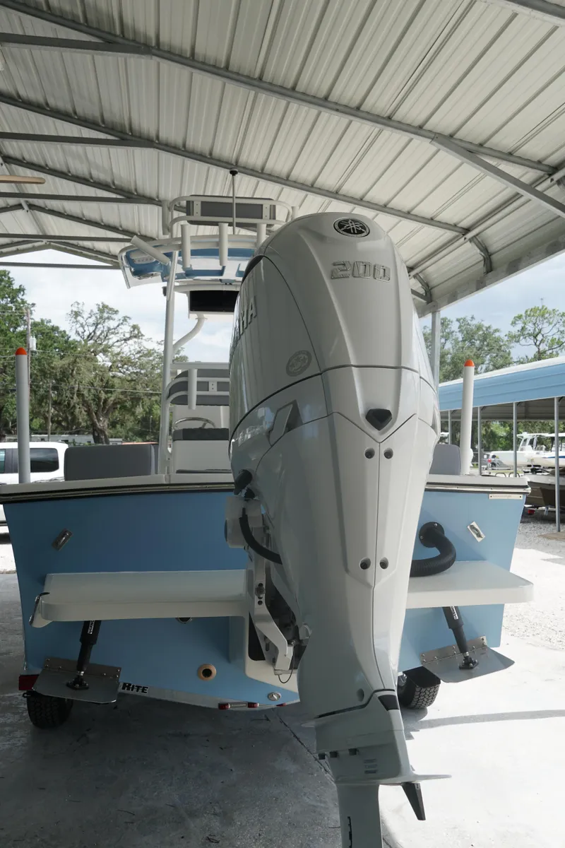 Slide: The Image of 2026 May-Craft 238 Center Console boat with Yamaha 200 engine under a metal canopy. - 45