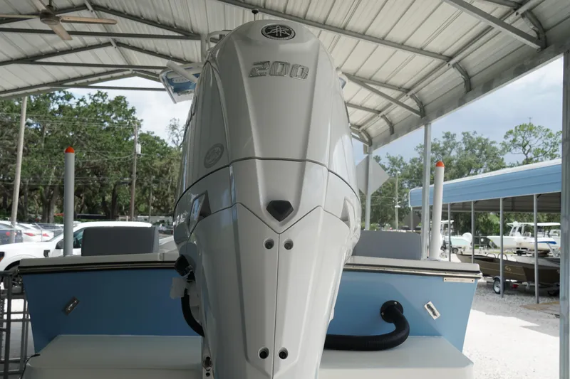 Slide: The Image of 2026 May-Craft 238 Center Console boat with powerful outboard motor under a metal canopy. - 46