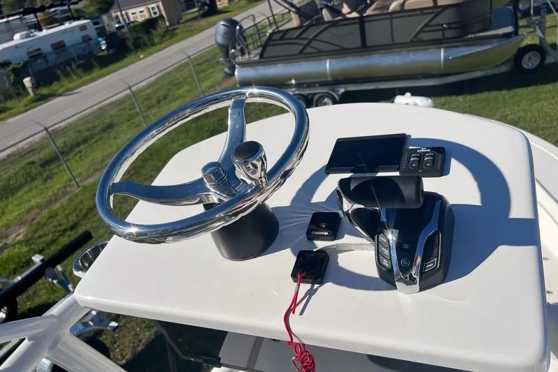 Slide: The Image of 2026 May-Craft 238 Center Console helm with steering wheel and controls. - 55