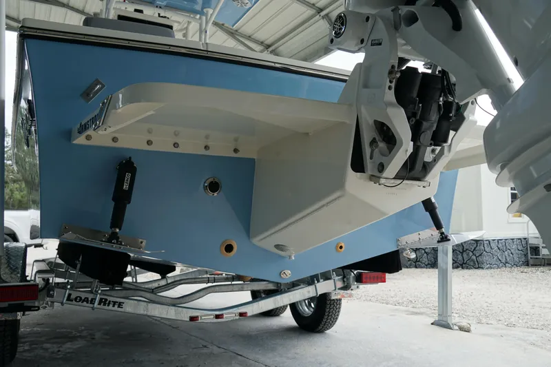 Slide: The Image of 2026 May-Craft 238 Center Console boat on trailer, rear view under shelter. - 7