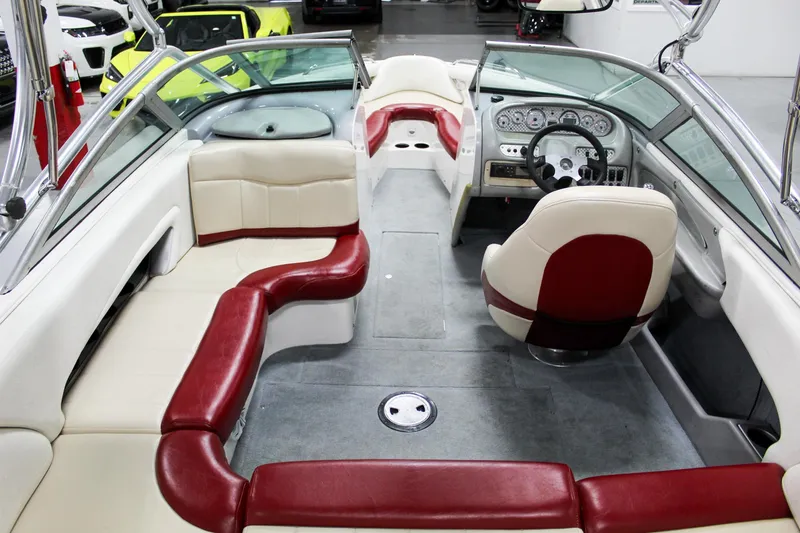 Slide: The Image of 2002 MasterCraft X-10 boat interior with red and white seating, steering wheel, and dashboard. - 11