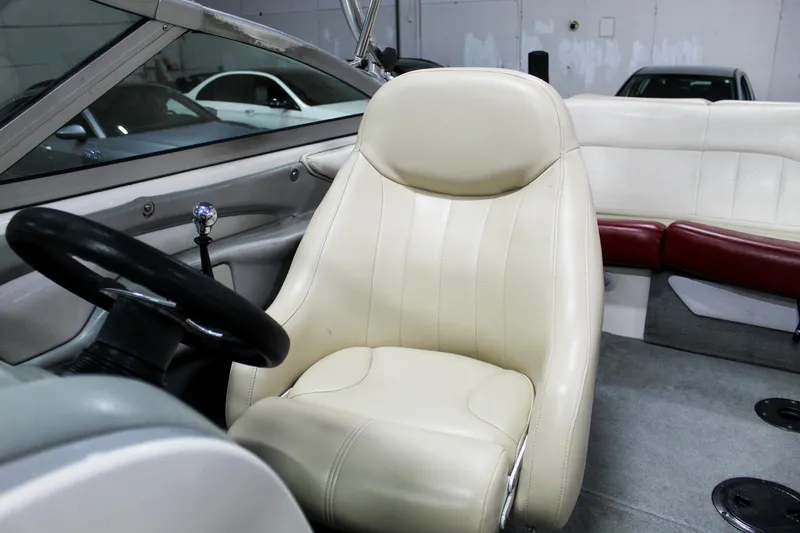 Slide: The Image of 2002 MasterCraft X-10 boat interior with cream leather seats and steering wheel. - 13
