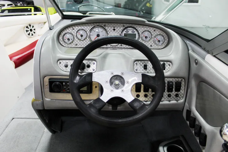 Slide: The Image of 2002 MasterCraft X-10 boat dashboard with steering wheel and instrument panel. - 15