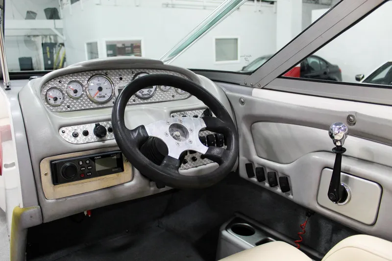 Slide: The Image of 2002 MasterCraft X-10 boat dashboard with steering wheel and control panel. - 16