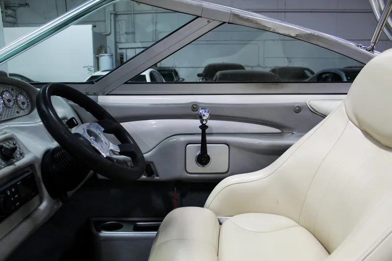 Slide: The Image of Interior of a 2002 MasterCraft X-10 boat with steering wheel and beige seating. - 18