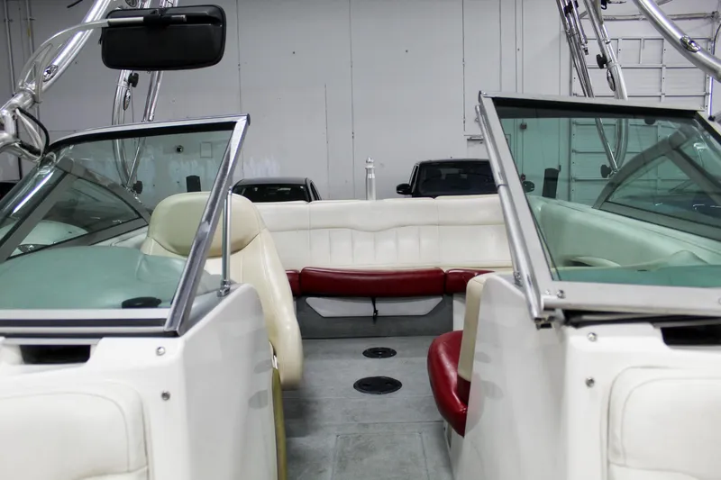 Slide: The Image of 2002 MasterCraft X-10 boat interior with white and red seating, in a garage setting. - 22