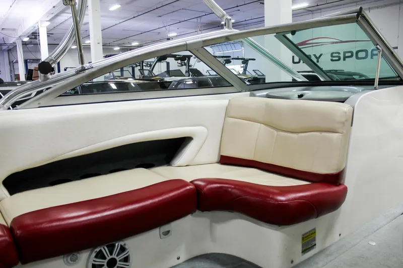 Slide: The Image of 2002 MasterCraft X-10 boat interior with red and beige seating in a showroom. - 23
