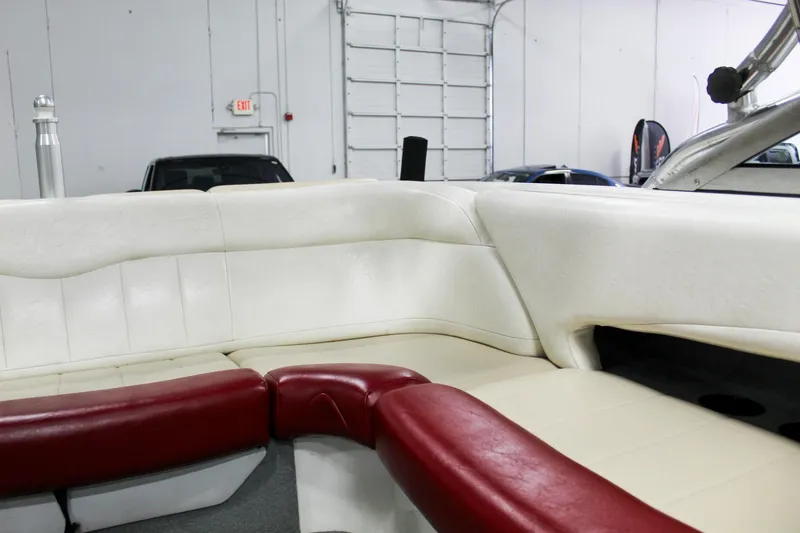 Slide: The Image of 2002 MasterCraft X-10 boat interior with white and red seating in a garage setting. - 24