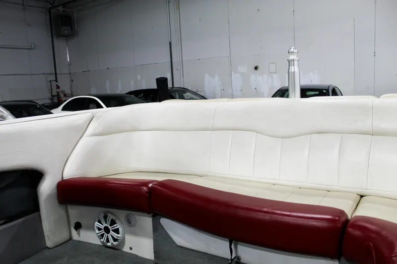 Slide: The Image of 2002 MasterCraft X-10 boat interior with white and red seating in a garage setting. - 25