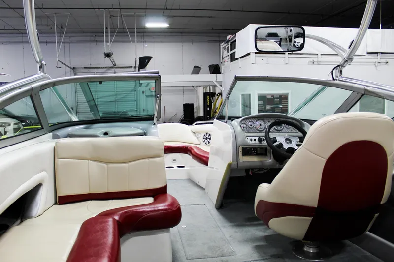 Slide: The Image of 2002 MasterCraft X-10 boat interior with red and white seating, dashboard, and steering wheel. - 28