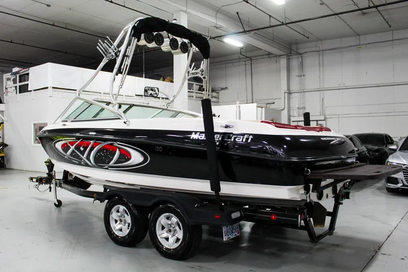 Slide: The Image of 2002 MasterCraft X-10 boat on trailer in indoor storage facility. - 3