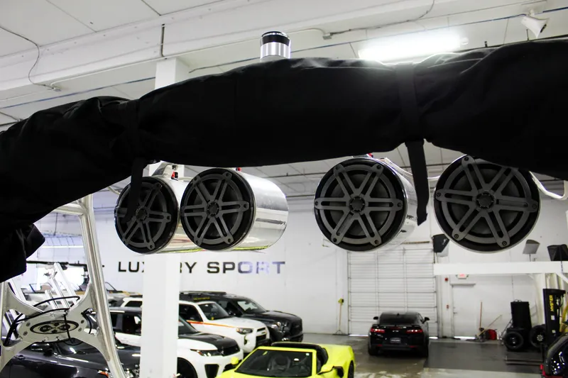 Slide: The Image of Speakers mounted on a 2002 MasterCraft X-10 boat in a luxury showroom. - 30