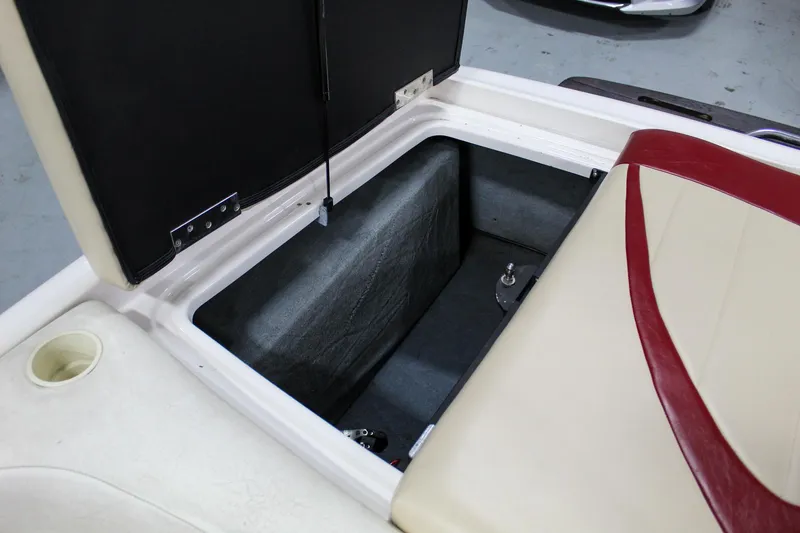 Slide: The Image of Open storage compartment in 2002 MasterCraft X-10 boat with beige and red seating. - 33