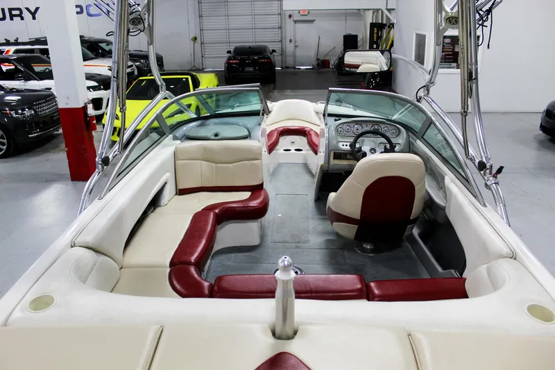Slide: The Image of 2002 MasterCraft X-10 boat interior with red and white seating, steering wheel, and dashboard. - 34
