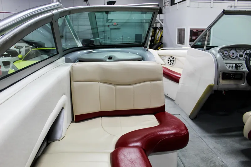 Slide: The Image of 2002 MasterCraft X-10 boat interior with cream and red seating, dashboard, and steering wheel. - 36