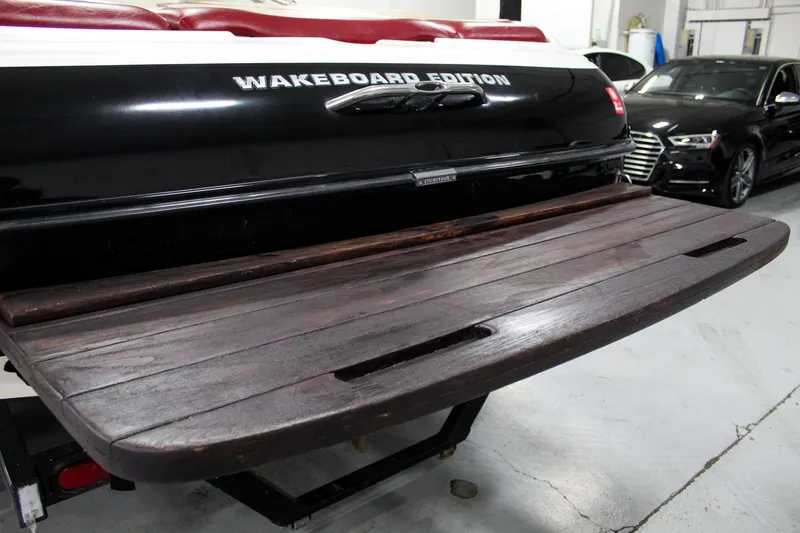 Slide: The Image of 2002 MasterCraft X-10 Wakeboard Edition with wooden swim platform in a garage. - 4