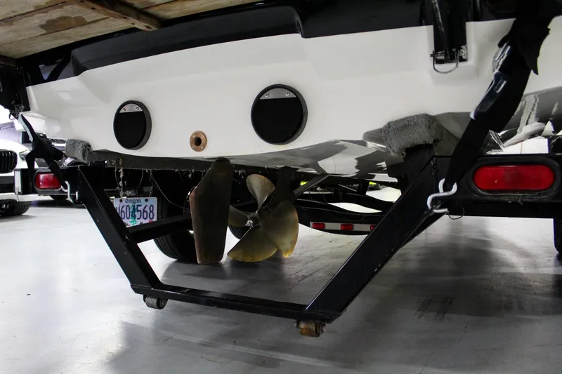 Slide: The Image of Rear view of a 2002 MasterCraft X-10 boat on a trailer, showing propeller and license plate. - 40