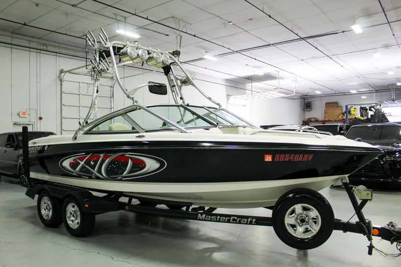 Slide: The Image of 2002 MasterCraft X-10 boat on trailer in indoor storage facility. - 8