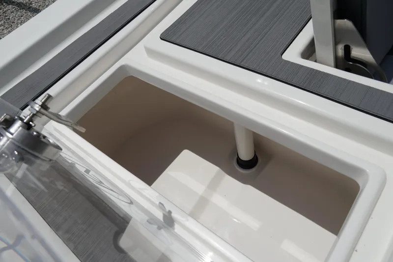 Slide: The Image of 2026 May-Craft 220 Bay boat interior, featuring a storage compartment and sleek design elements. - 10