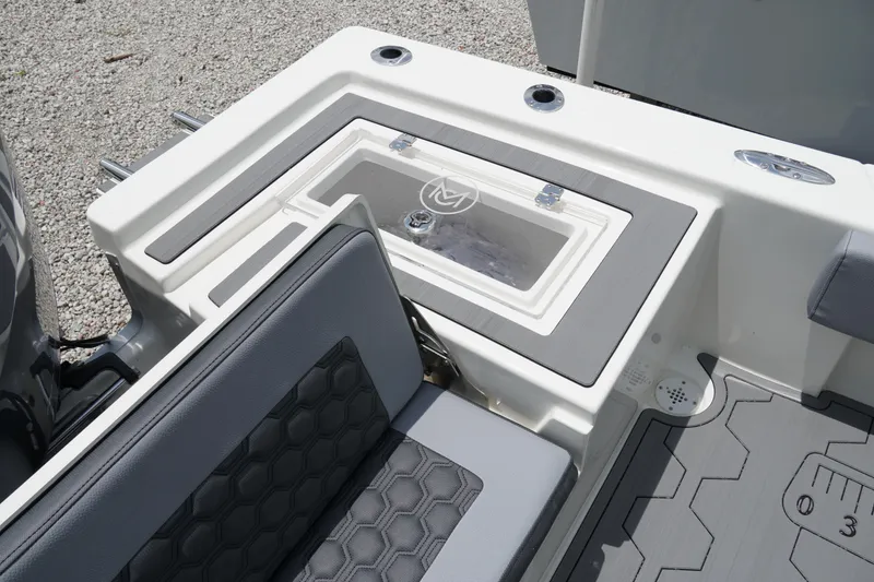 Slide: The Image of 2026 May-Craft 220 Bay boat interior with seating and storage compartment. - 11