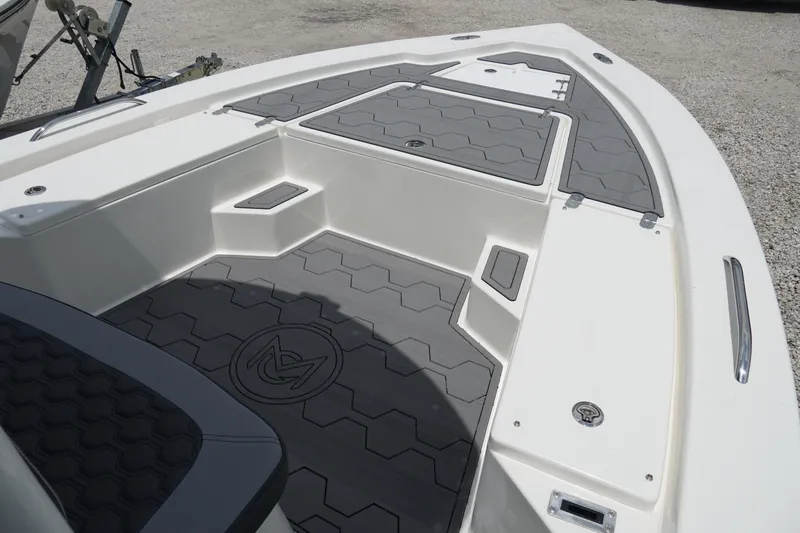 Slide: The Image of 2026 May-Craft 220 Bay boat deck with gray non-slip flooring and storage compartments. - 14