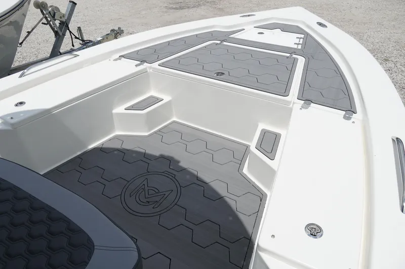 Slide: The Image of 2026 May-Craft 220 Bay boat deck with gray non-slip surface and storage compartments. - 15