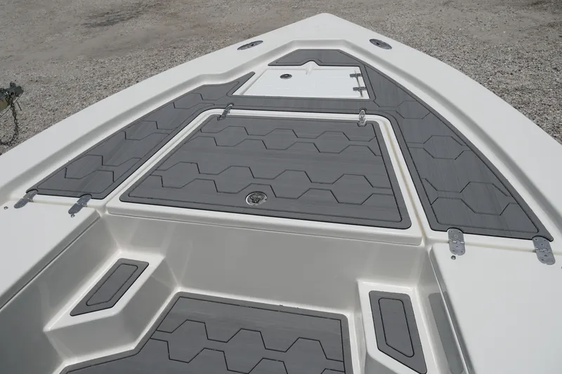 Slide: The Image of 2026 May-Craft 220 Bay boat deck with gray non-slip surface and storage compartments. - 16