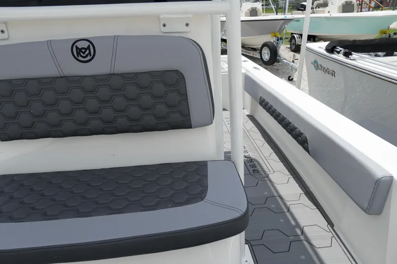 Slide: The Image of 2026 May-Craft 220 Bay boat interior with hexagonal-patterned seating and sleek design. - 20