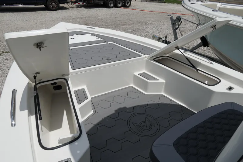 Slide: The Image of 2026 May-Craft 220 Bay boat interior with open storage compartments and hexagonal floor design. - 24